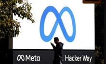 A man walks by Meta headquarters in Menlo Park, California.