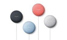 Four mini Google Nests pictured against a white background.