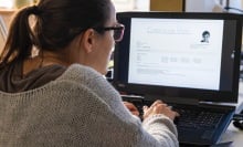 woman working on job resume on laptop