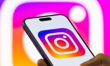 An Instagram logo on a phone in front of another Instagram logo. 