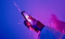 cybersecurity concept art of arm holding smartphone wrapped in glowing fiber optic cables