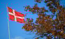 The danish flag is flying upon a state government building
