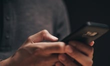 Closeup of a man using a smartphone in the dark