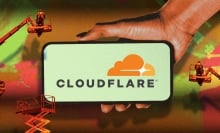 Cloudflare logo on phone screen with construction site background
