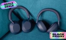 two sony headphones on a couch with stickers that read 'black friday' and 'deals'