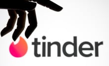 tinder logo with robotic hand looming above