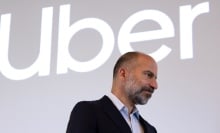 The Uber logo above its CEO, who is looking pensive