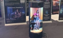 Holodeck of 3D-generated woman in a small tublar object.