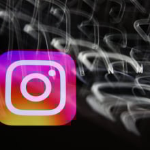 The Instagram logo amid a swirl of blurred white lights on a black background. 