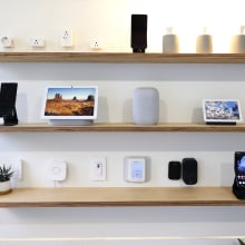 Several Google and Nest devices, including the Nest Audio speaker, Nest Hub 2nd Generation and Nest Hub Max displays, the GE Cync Wifi Soft White Smart Bulb, and the Philips Hue A19 Smart Bulb smart lightbulbs, The Philips Hue Smart Plug and the C by GE Smart Plug, exhibited on the Android Smart Home display