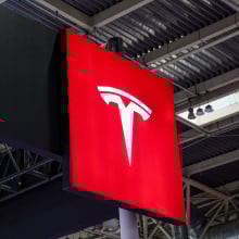 tesla logo high up in a conference room