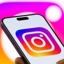 An Instagram logo on a phone in front of another Instagram logo. 