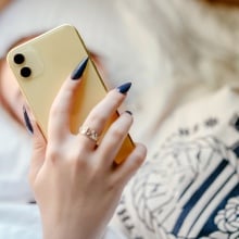 A teenage girl looks at her phone.