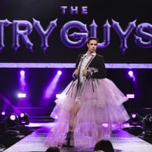 Keith Habersberger of the Try Guys in a pink dress and black jacket