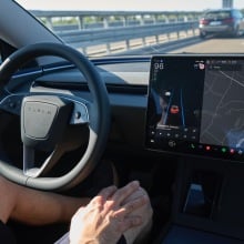 a tesla driver on the highway goes hands free in full self driving mode