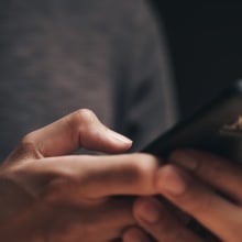 Closeup of a man using a smartphone in the dark