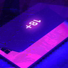 partly-closed laptop with an 18+ sticker on it