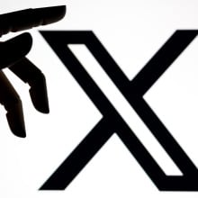 X logo with robot hand