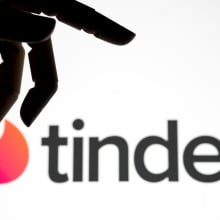 tinder logo with robotic hand looming above