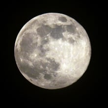 The full moon in the night sky.