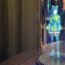 Holodeck device with generated gamer girl in green blouse and skirt