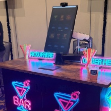 Neon covered table for an AI bartender at CES 2026.