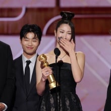 Ejae accepts award at Golden Globes.