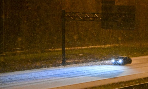 A car drives along a road during a winter storm on January 21, 2025 in Tallahassee, Florida