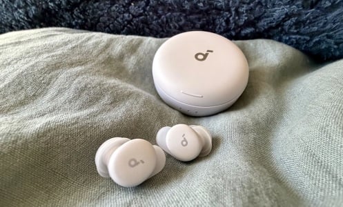 lilac sleep a30 special earbuds on light blue comforter in front of dark blue pillow