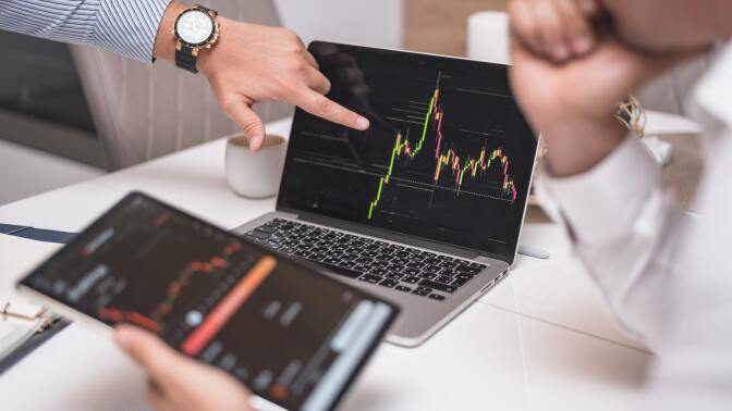 people looking at trends on a laptop