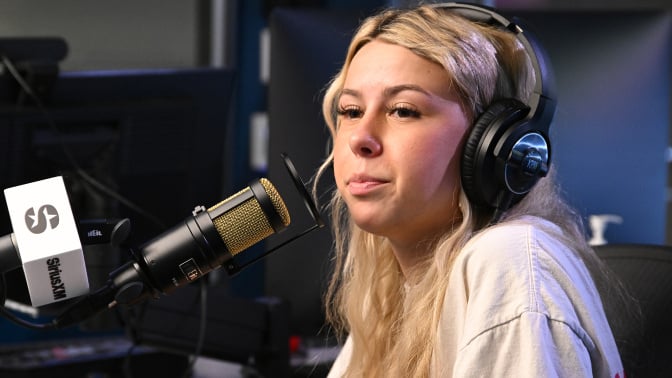haliey welch sitting in front of a micrphone
