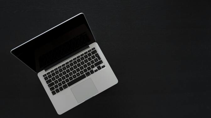 Laptop on black surface
