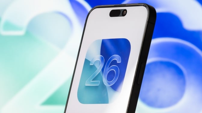 An iPhone with the iOS 26 logo