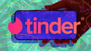 hand holding phone with tinder logo