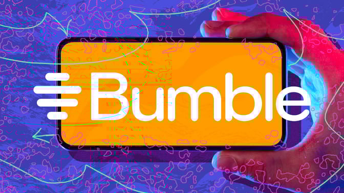  Hand holding phone with Bumble logo against abstract background