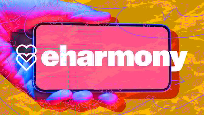 Hand holding phone with eharmony logo against abstract background