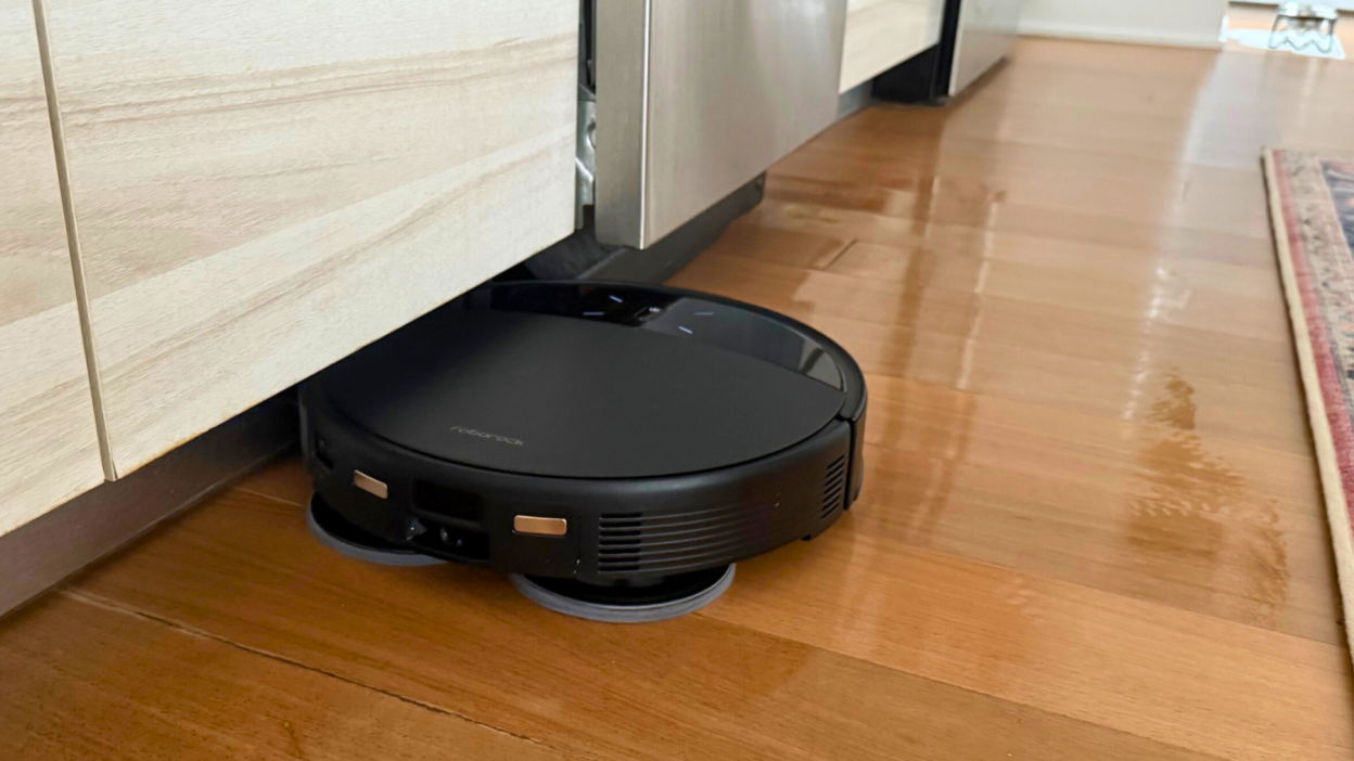 Roborock Saros 10R robot vacuum mopping hardwood kitchen floor under counter