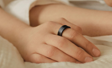 A person's hand wearing a black Samsung Galaxy Ring.