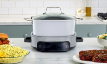 Ninja Foodi PossibleCooker on countertop with various foods