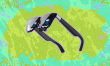 Xreal One Pro AR Glasses against a green background. 