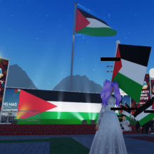 A screenshot from inside the experience. A large Palestinian flag is seen in the background.