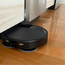 Roborock Saros 10R robot vacuum mopping hardwood kitchen floor under counter