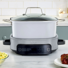 Ninja Foodi PossibleCooker on countertop with various foods