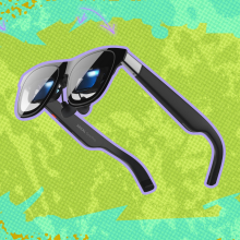 Xreal One Pro AR Glasses against a green background. 