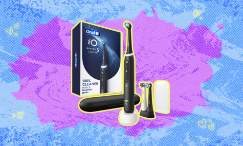 Oral B toothbrush against a purple and blue background. 