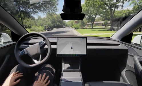 Inside a Tesla, a driver uses Full Self Driving.
