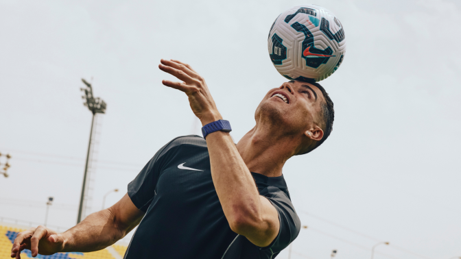 A photo of Christiano Ronaldo hitting a soccer ball with his head.