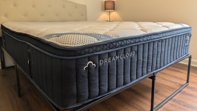 the dreamcloud premier hybrid mattress in a bedroom with no sheets
