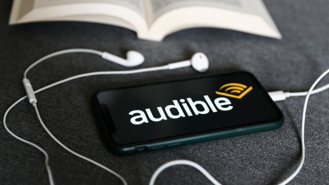 Audible app on phone with earbuds attached