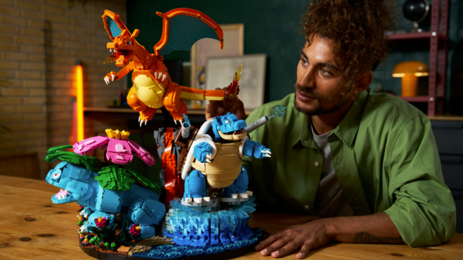 man building Venusaur, Charizard and Blastoise Lego set